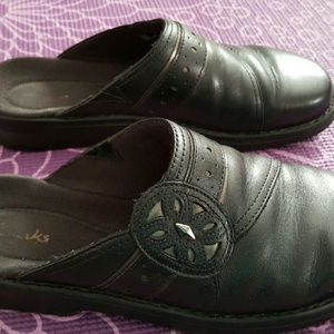 Black Clark slide on shoes.